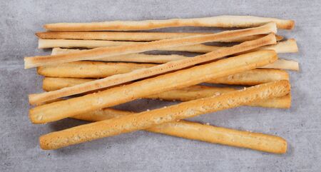 Bread sticks with salt  top view on a grey  background.の写真素材