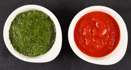 Green sauce and red pepper sauce. Top view. Flat lay.