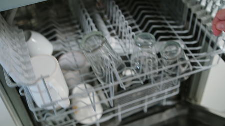 Clean glasses and cups after washing in a dishwasher machine. Close-up shotの写真素材