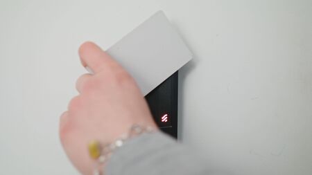 Lublin, Poland - November 2017: Close up of a woman using a modern intercom at a residential building entrance.のeditorial素材
