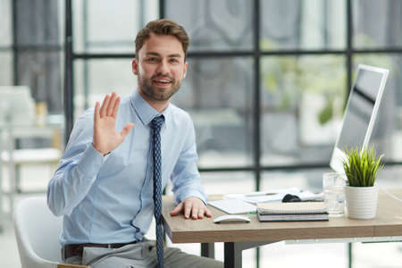 Hello by Man in Office, Indoor Waving Handの写真素材