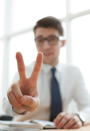 Young businessman man showing number two with fingers on handの写真素材