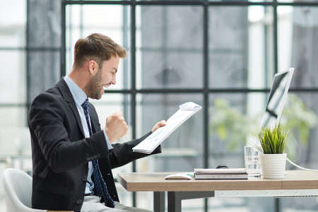 funny male employee have fun perform winner in modern officeの写真素材