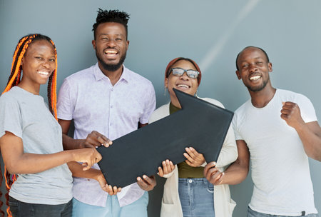 Young african american friends holding black arrow