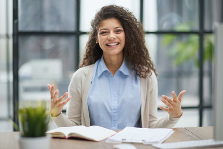 Image of young beautiful joyful woman while working