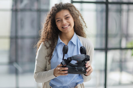 positive woman wearing virtual reality goggles headsetConnection, technology, new generation,...