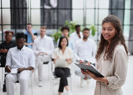 Selective focus of lecturer talking to audience during seminar in conference roomの写真素材