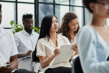 Millennial employees gathered in boardroom for trainingの写真素材