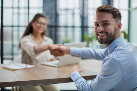Handshake of business people sitting at the table in the officeの写真素材