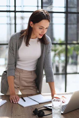 Business woman working on laptop computer in officeの写真素材