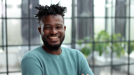 a confident black guy in a green jacket close-up.の写真素材