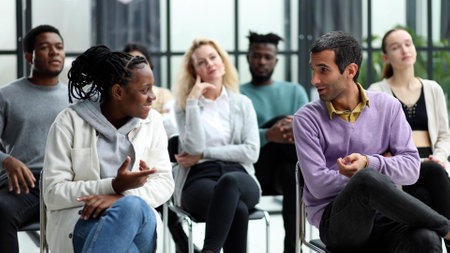 young people shaking hands in a circle of like-minded peopleの写真素材