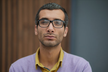 Charming handsome. Handsome young man in casual wear keeping arms crossed while standingの写真素材