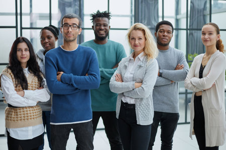 Group of business people standing at the window of a modern officeの写真素材