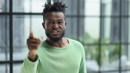 Handsome businessman pointing his finger to the cameraの写真素材