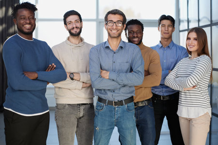 Diverse business people stand in the lobby of a modern office.の写真素材