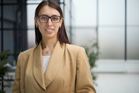 Portrait of a young beautiful business woman in the officeの写真素材