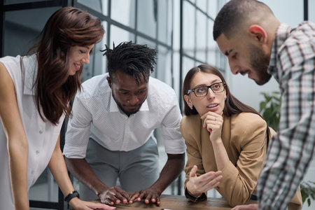 Cheerful colleagues discussing project in modern office
