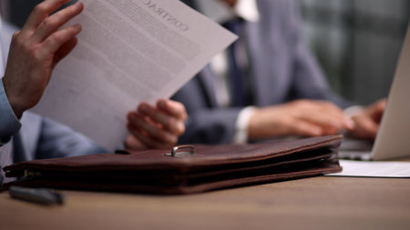 Close-up of businessman keeping hands on contractの写真素材