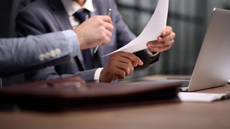Close-up of businessman keeping hands on contract