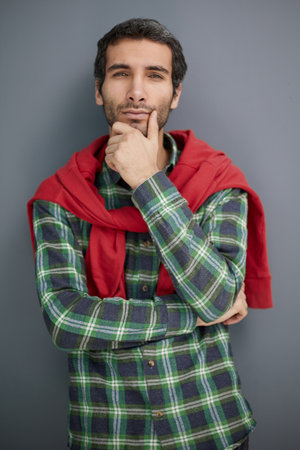 Portrait of bored, propping up his head young man with beard wearingの写真素材