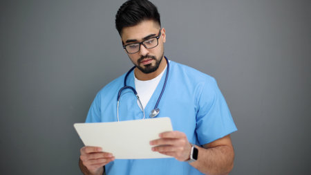 doctor doing paperwork checking medical documents at workplace.
