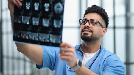 Confident doctor with x-ray picture in officeの写真素材
