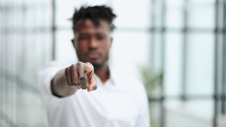 businessman pointing while standing in modern officeの写真素材