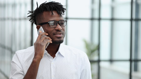 young adult african american hipster business man professional making business callの写真素材