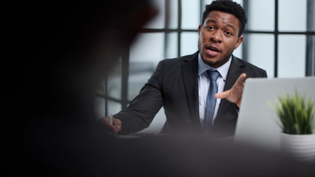 Focused young businessman signing agreement with skilled lawyerの写真素材