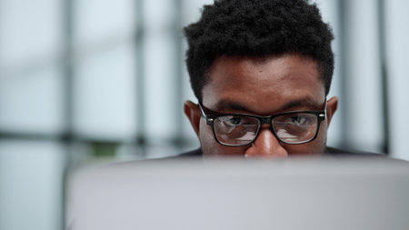 Technology that matches their target driven company. Shot of a young businessman using a computer in a modern office.の写真素材