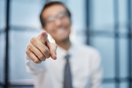 Young businessman points his finger at an objectの写真素材