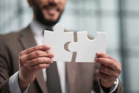 happy businessman holding a puzzle in his hands. Business decisions, success and strategy.の写真素材
