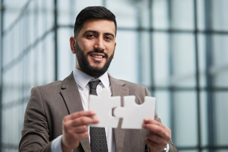 happy businessman holding a puzzle in his hands. Business decisions, success and strategy.の写真素材