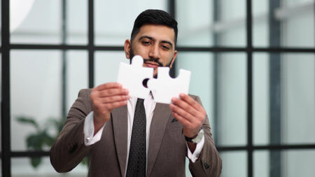 businessman show white jigsaw in hand, business strategy conceptの写真素材