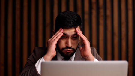 businessman with hands behind head resting in comfortable office.の写真素材