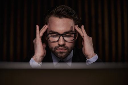 You shouldnt have to think twice about going online. a handsome young businessman sitting behind his laptop in his office.の写真素材