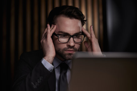 You shouldnt have to think twice about going online. a handsome young businessman sitting behind his laptop in his office.の写真素材