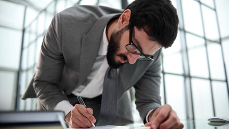 a man puts his signature on legal documents, makes an investment dealの写真素材