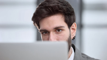 Businessman using a laptop while working late in his officeの写真素材