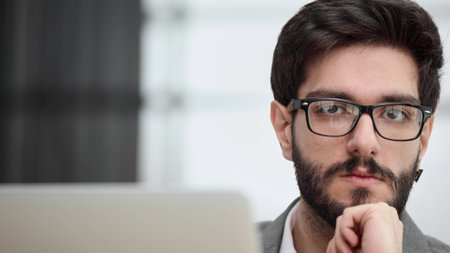 Businessman using a laptop while working late in his office