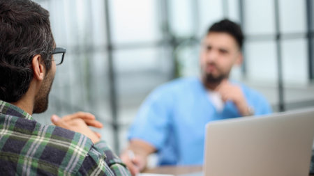 Doctor talking to a patient in a consultation at the officeの写真素材