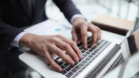 businessman finger typing on computer keyboard in officeの写真素材