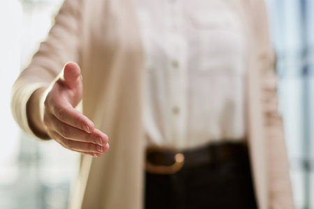 casual woman in white shirt makes a welcoming gesture