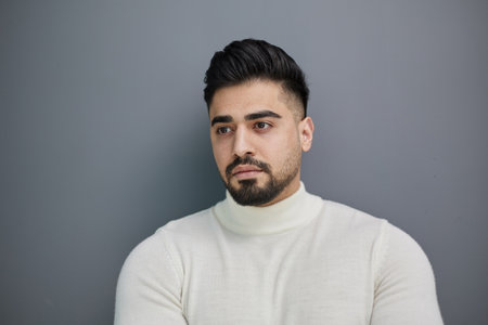 Portrait of stylish middle aged man posing on gray backgroundの写真素材