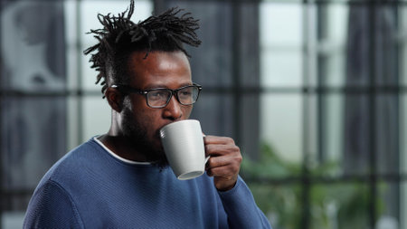 Portrait of a young businessman with a cup of coffeeの写真素材