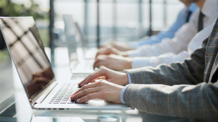 Businessman working and typing on laptop keyboard, surfing the internet, digital tablet on office...