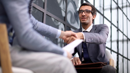 Shot of businessmen making a deal after viewing a documentの写真素材