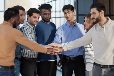 Happy colleagues welcome businessman to their successful team