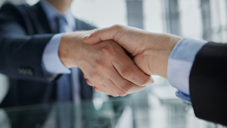 Real estate broker agent Shake hands after customer signing contract document for ownership realty purchase in the officeの写真素材